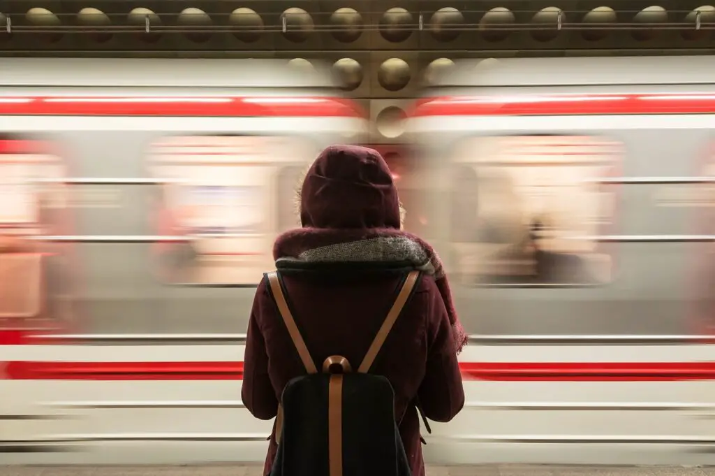 Smart Transportation: Essential Travel Tips for Every Journey Travelers waiting at a train station with luggage, planning their next transportation step.