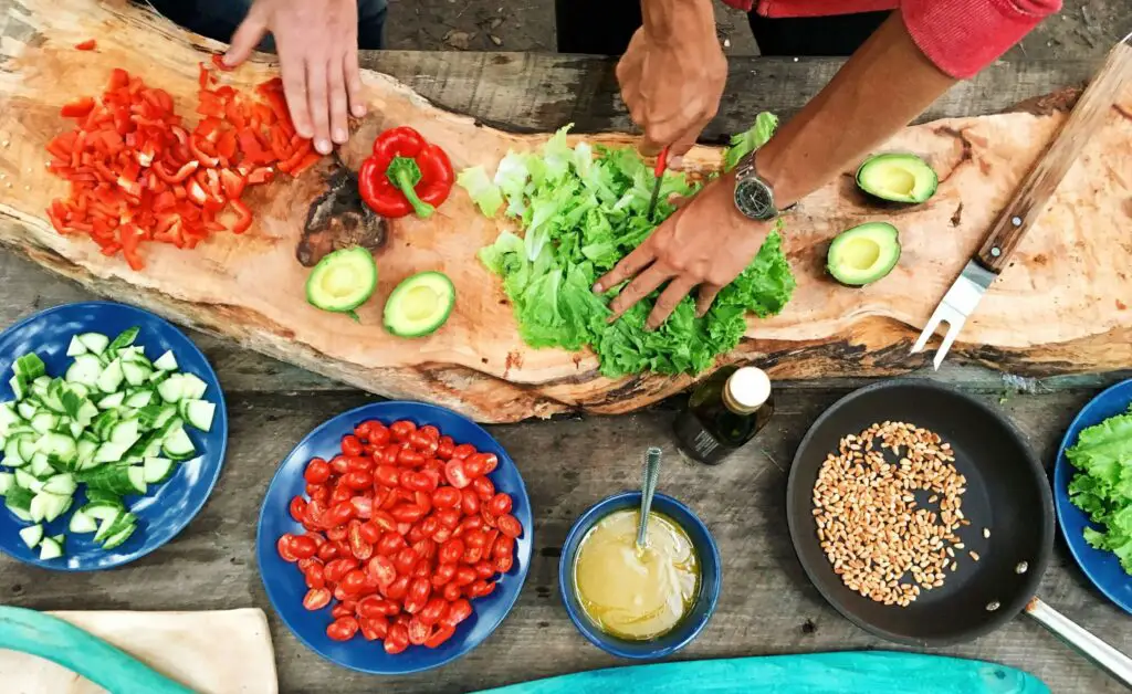 Interactive Cooking Classes: Savor the Experience in Chicago Hands of a couple chopping vegetables together during an interactive cooking class in Chicago.