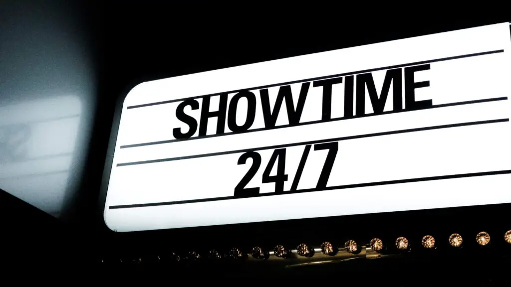 Live Comedy Shows: Laughter as the Best Bond for Fun Group Activities in Chicago A brightly lit "Showtime" sign outside a comedy club, inviting groups to enjoy a night of laughter in Chicago.
