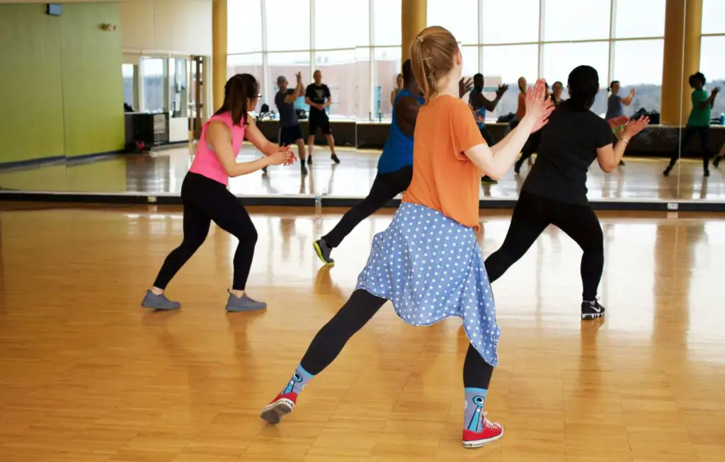 Dynamic Dance Classes: Move to the Rhythm in Chicago Group of women dancing energetically in a studio during a fun adult dance class in Chicago.