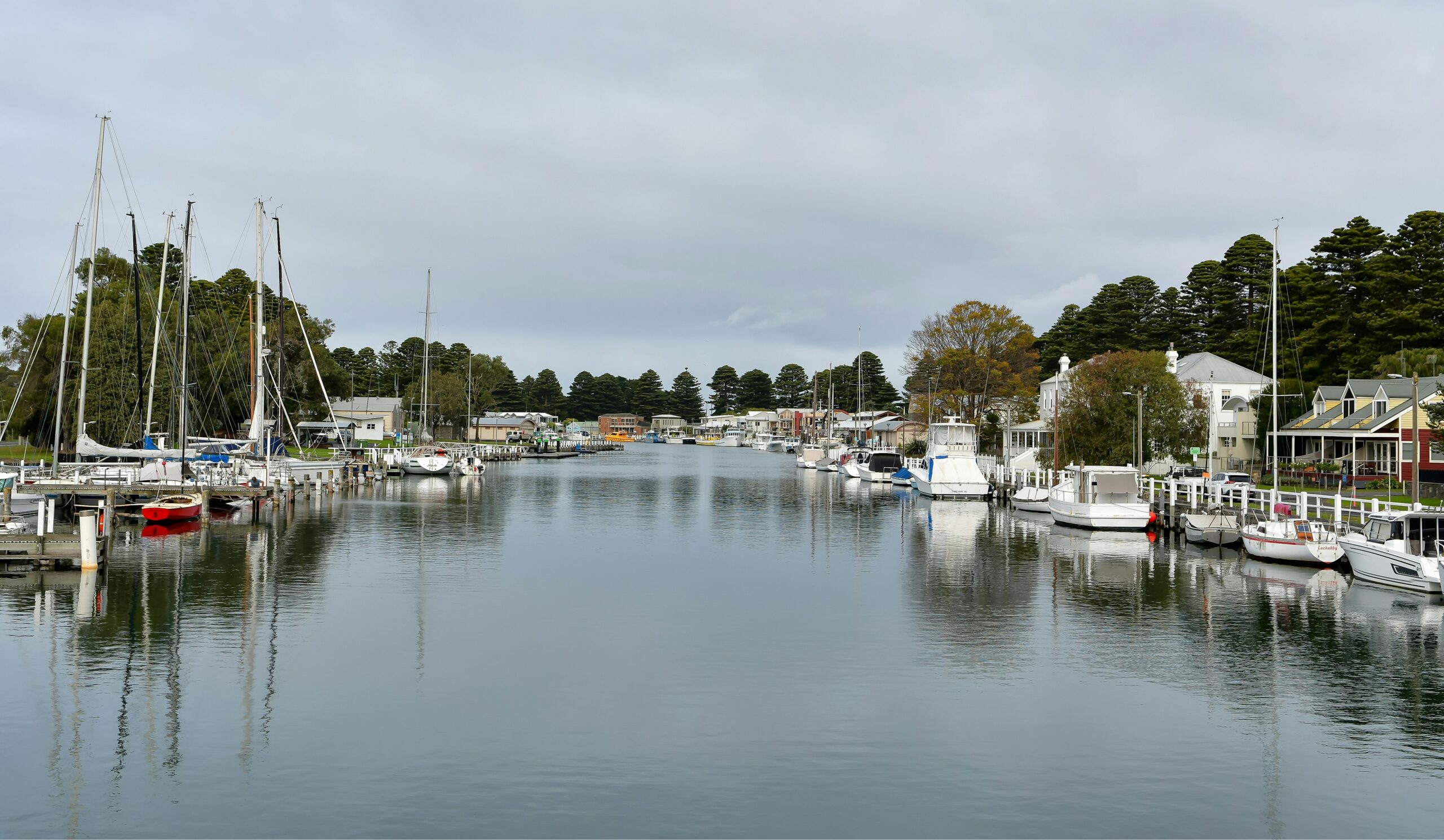 Small scenic harbor in Mystic, CT with historic boats near local museums.