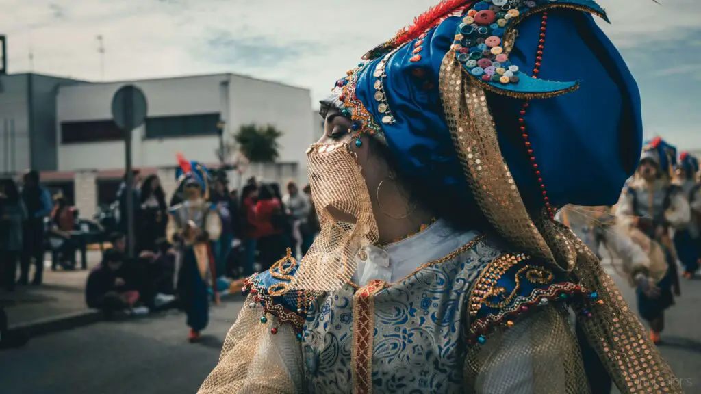 Cultural Experiences and Community Engagement Young woman in traditional folkloric attire dancing in the street as a crowd watches and enjoys the cultural performance.