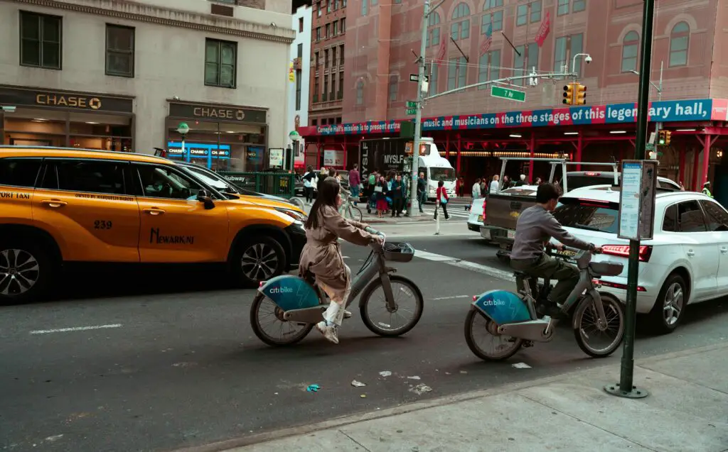 Understanding the Vibrancy of NYC During Labor Day Weekend: Things to Do in New York City A lively NYC street on a sunny weekend day, filled with people walking, outdoor dining, and festive energy.