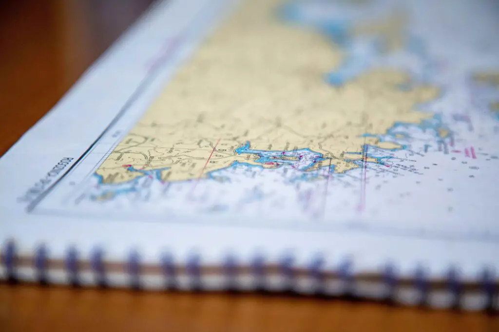 Insider Tips for Planning Your Epic Journey: Epic Universe Tickets A detailed theme park map laid out on a table, with notes, a pen, and tickets—ready for planning an Epic Universe adventure.