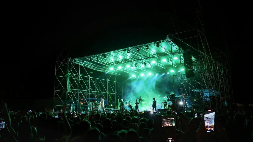 Crowd enjoying a lively concert in Galena, with bright lights and an energetic atmosphere.