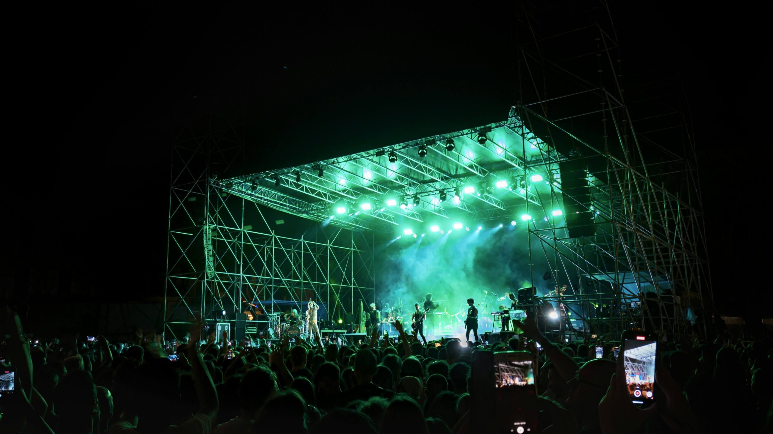Crowd enjoying a lively concert in Galena, with bright lights and an energetic atmosphere.