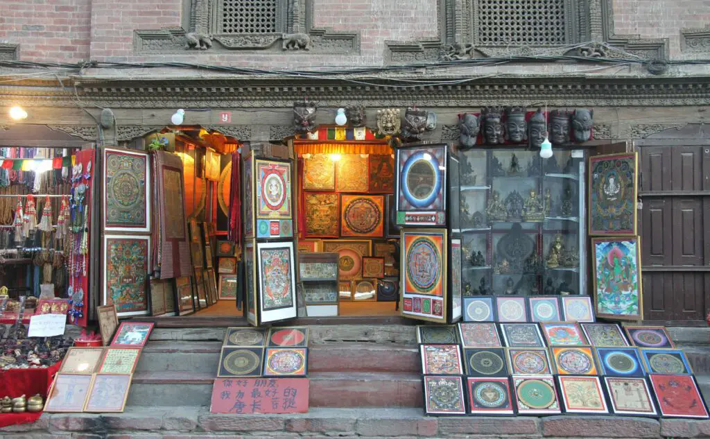 Small artisan shop in East Village displaying handmade artwork and crafts, including paintings and decorative items.