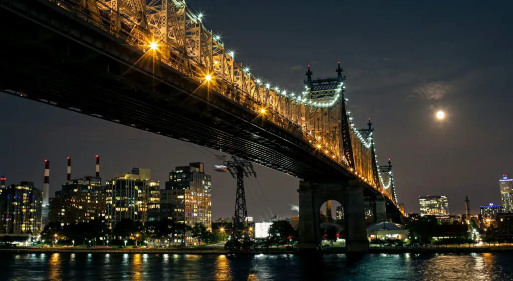 Stunning nighttime view of the Brooklyn Bridge illuminated against the New York City skyline.