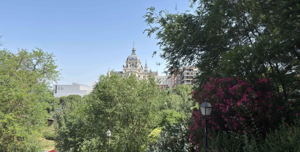 Stunning view of Almudena Cathedral’s grand facade under a bright sky, highlighting its intricate architecture in Madrid. 