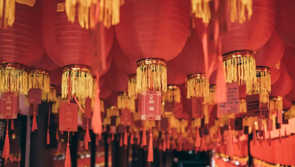 Colorful traditional Chinese decorations hanging in the streets of Chinatown NYC, celebrating cultural heritage and festivals.

