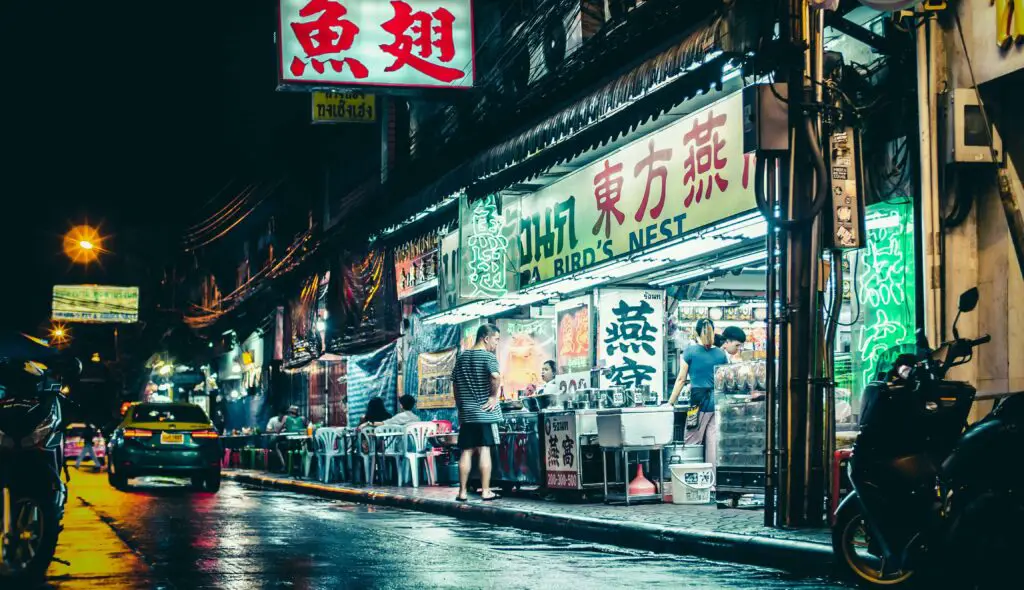 People shopping in a colorful store in Chinatown NYC, surrounded by unique goods, lanterns, and traditional décor.

