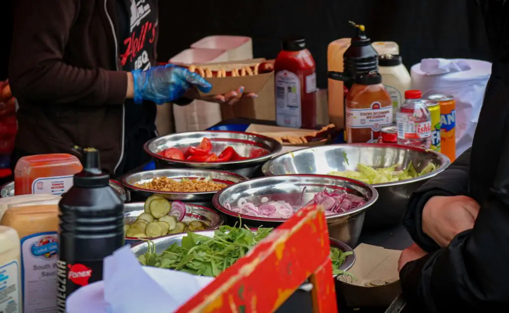 Indulge in an Iconic West Village Food Tour (Beyond the Cupcake) Street food stand in West Village selling hot dogs, attracting people to enjoy classic New York flavors.