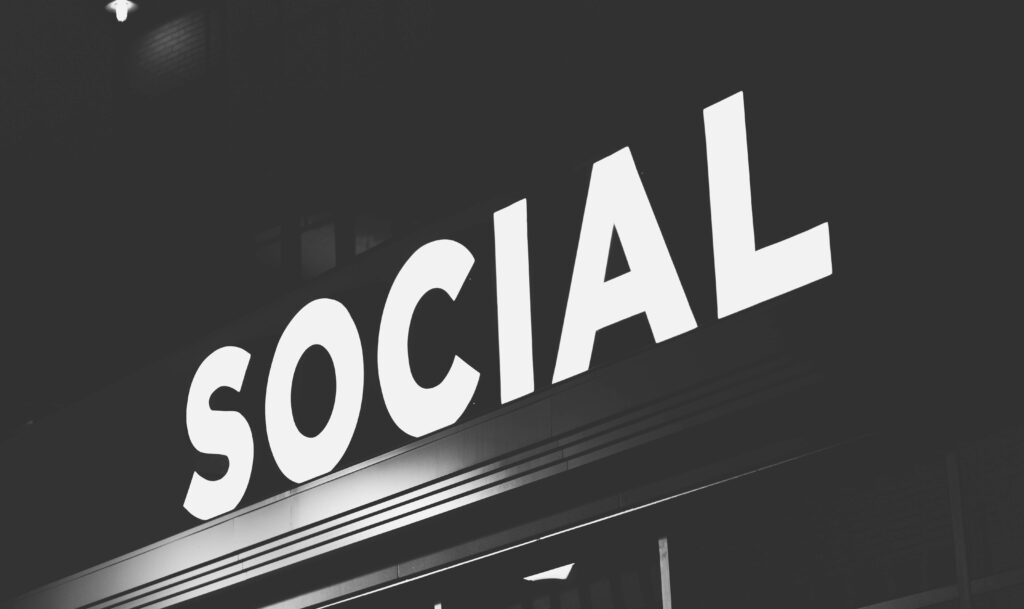 Social Hubs and Active Indoor Fun: Indoor Activities in Brooklyn for Adults Illuminated sign with the word “Social” glowing in a modern indoor venue, symbolizing active community spaces in Brooklyn.