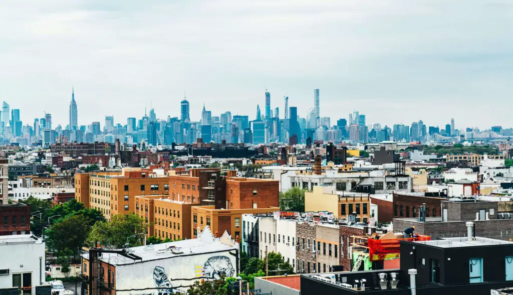 Aerial view of Bushwick, NYC, showing colorful buildings, murals, and lively neighborhood streets.