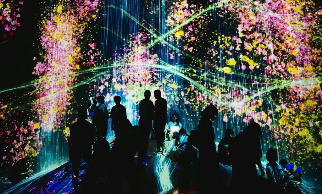 World-Class Entertainment and Dazzling Shows: Things to Do in Las Vegas Besides Gamble Group of people watching a live performance in Las Vegas, enjoying the dazzling lights and world-class entertainment.